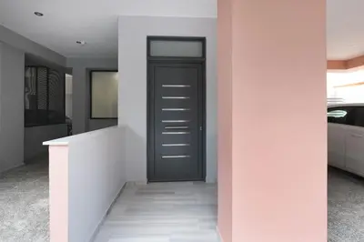 a hallway with a black door on a white wall at Elegant Studio Near Seafront- Palaio Faliro by MPS in Athens