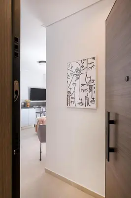 a hallway with a painting hanging on a wall at Elegant Studio Near Seafront- Palaio Faliro by MPS in Athens