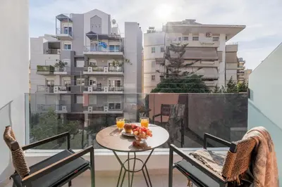 a balcony with a table with fruit and drinks on it at Elegant Studio Near Seafront- Palaio Faliro by MPS in Athens