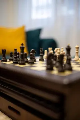 a chess board with black chess pieces on it at Lysé Athens in Athens