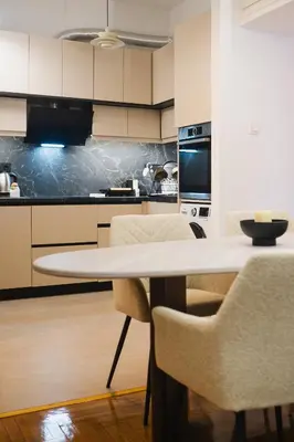 a kitchen with a white table and chairs at Lysé Athens in Athens