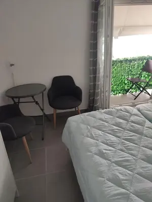 a bedroom with a bed and a table and chairs at By the wave luxurious studios in Piraeus