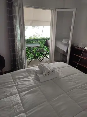 a bedroom with a bed with two towels on it at By the wave luxurious studios in Piraeus