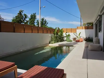 a swimming pool in the backyard of a house at Camara Athens Riviera Home in Aghia Marina