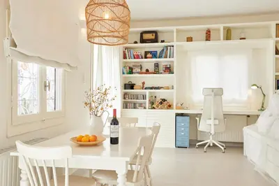 a white dining room with a white table and chairs at Camara Athens Riviera Home in Aghia Marina