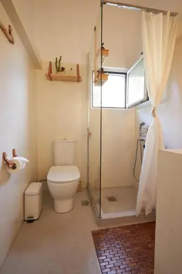 a bathroom with a toilet and a shower at Camara Athens Riviera Home in Aghia Marina