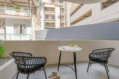 two chairs and a table in a room at Boutique Studio ΙV in Central Athens by MPS in Athens