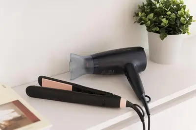 a blow dryer on a table next to a plant at Boutique Studio ΙV in Central Athens by MPS in Athens