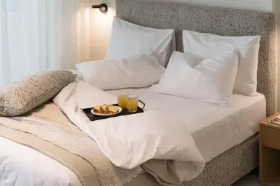 a bed with a tray of food and drinks on it at Boutique Studio ΙV in Central Athens by MPS in Athens
