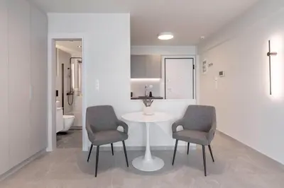 a white room with two chairs and a table in it at Boutique Studio ΙV in Central Athens by MPS in Athens