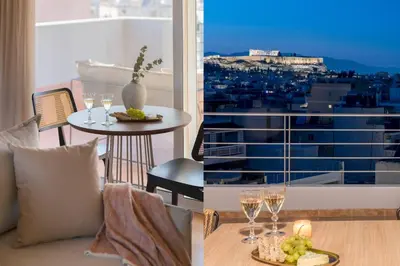 a living room with a couch and a table with wine glasses at Panoramic Acropolis View Rooftop Studio by MPS in Athens