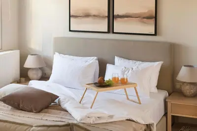 a bed with a table on it with two lamps at Panoramic Acropolis View Rooftop Studio by MPS in Athens