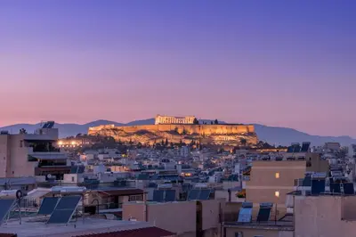a view of the acropolis ofhens from a city at sunset at Panoramic Acropolis View Rooftop Studio by MPS in Athens