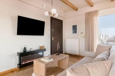 a living room with a couch and a fireplace at Panoramic Acropolis View Rooftop Studio by MPS in Athens