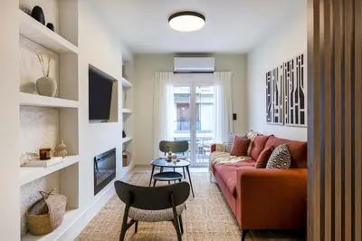 a living room with a couch and a table at Piraeus Terra Residence - Family 2 BDRM by MPS in Piraeus