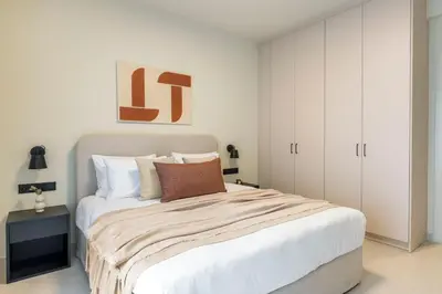 a bedroom with a large bed with white cabinets at Piraeus Terra Residence - Family 2 BDRM by MPS in Piraeus