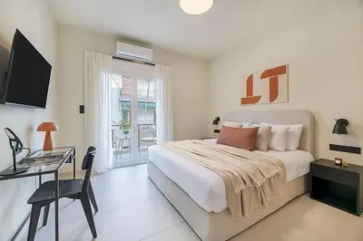 a white bedroom with a bed and a desk at Piraeus Terra Residence - Family 2 BDRM by MPS in Piraeus