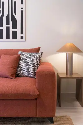 a living room with a red couch and a lamp at Piraeus Terra Residence - Family 2 BDRM by MPS in Piraeus