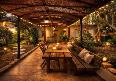 an outdoor patio with a wooden bench and a table at Cosy House With Garden Glyfada in Athens
