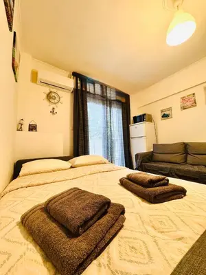 a bedroom with two beds with towels on them at Athenian Riviera beach apartment in Athens