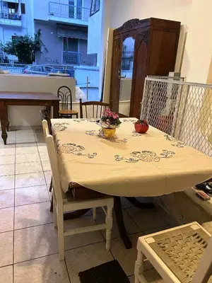 a table with a white table cloth on it with at Private room for 3 in a dorm 5' from metro in Athens