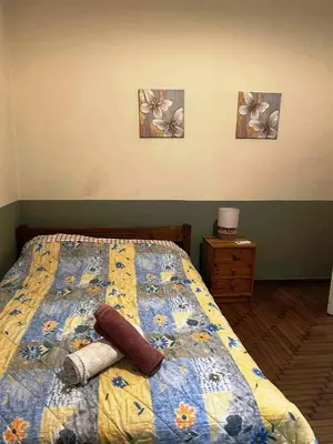 a bedroom with a bed with three pictures on the wall at Private room for 3 in a dorm 5' from metro in Athens