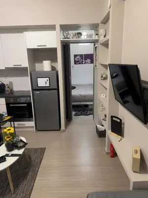 a living room with a television and a bedroom at #Greek Homely Space Βy Marianthi - In the heart of Athens in Athens
