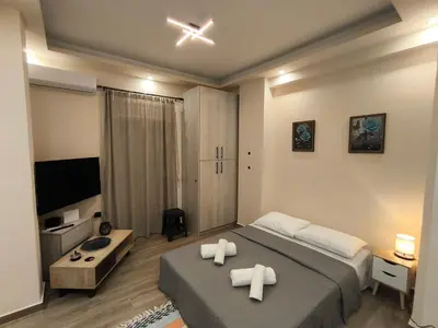 a bedroom with a bed with two white towels at Cozy Harbor Studio Just 3 min from Piraeus Port in Piraeus