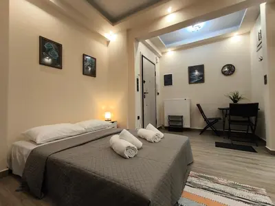 a bedroom with a bed with towels on it at Cozy Harbor Studio Just 3 min from Piraeus Port in Piraeus