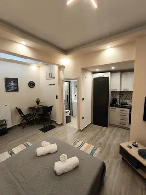 a room with a bed with two towels on it at Cozy Harbor Studio Just 3 min from Piraeus Port in Piraeus