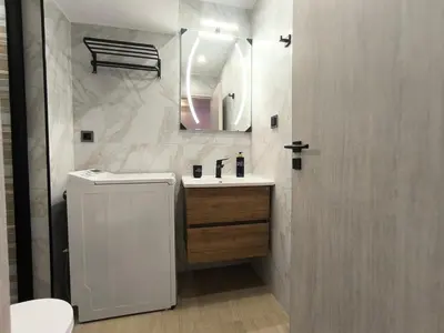 a white bathroom with a sink and a mirror at Cozy Harbor Studio Just 3 min from Piraeus Port in Piraeus