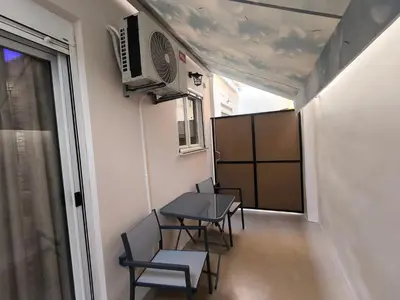 a small dining room with a table and chairs at Cozy Harbor Studio Just 3 min from Piraeus Port in Piraeus