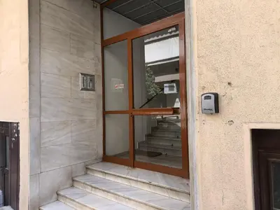 a glass door on a building with stairs in it at Cozy Harbor Studio Just 3 min from Piraeus Port in Piraeus