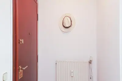 a clock on a wall next to a door at Kassandra lovely floor appartment in Patriarchou Ioakim the heart of Kolonaki in Athens