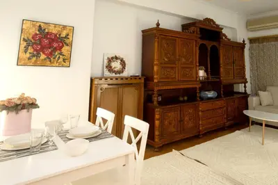 a living room with a table and a dining room at Kassandra lovely floor appartment in Patriarchou Ioakim the heart of Kolonaki in Athens