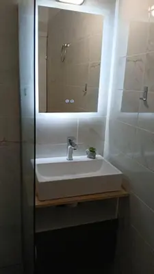 a bathroom with a white sink and a mirror at Athens Apartments, Piraeus Port in Athens