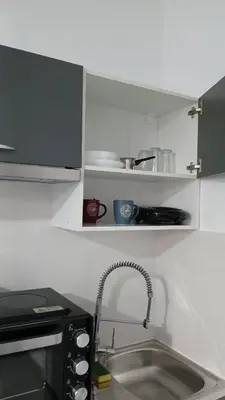 a kitchen with a sink and a counter top at Athens Apartments, Piraeus Port in Athens