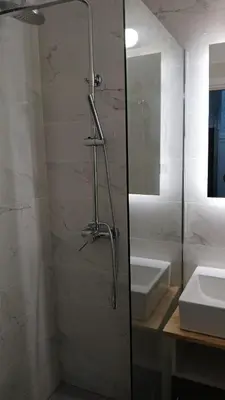 a bathroom with a shower and a sink at Athens Apartments, Piraeus Port in Athens