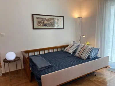 a bedroom with a bed with blue sheets and pillows at Seaview Jazmin Nest in Athens