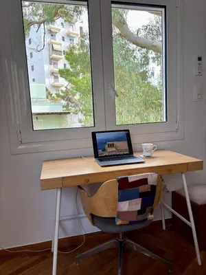 a laptop computer sitting on a desk in front of a window at Seaview Jazmin Nest in Athens
