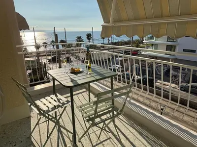 a table and chairs on a balcony with a view of the ocean at Seaview Jazmin Nest in Athens