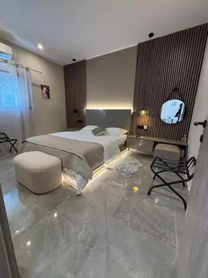 a bedroom with a large bed and a chair at Athens Air B&B in Athens