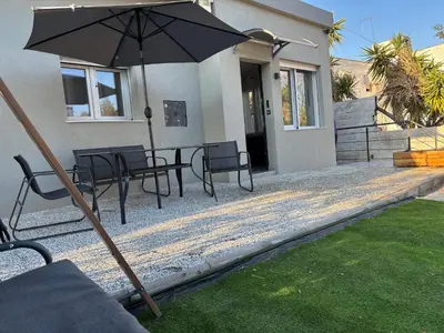 a patio with a table and chairs and an umbrella at Athens Air B&B in Athens