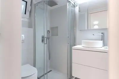 a bathroom with a shower and a toilet and a sink at White Harmony - 2BD Apt close to metro in Athens