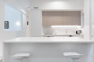 a white kitchen with white counters and white cabinets at White Harmony - 2BD Apt close to metro in Athens