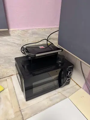 a laptop computer sitting on top of a microwave at illusion 2 in Piraeus
