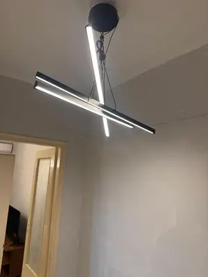a light hanging from a ceiling in a room at illusion 2 in Piraeus
