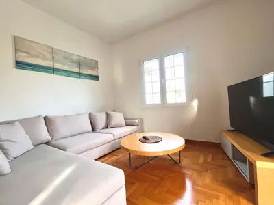 a living room with a couch and a table at Hellenic Coastal Residence in Athens