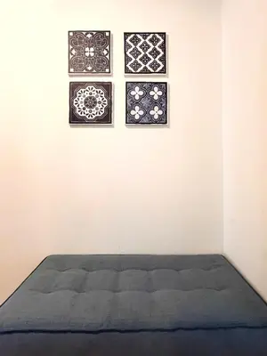 a bedroom with three framed pictures on the wall at Hellenic Coastal Residence in Athens