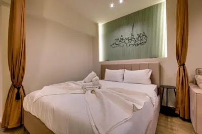a bedroom with a white bed with a bow on it at Sweet Dispotition-Modern ground flat next to metro in Athens